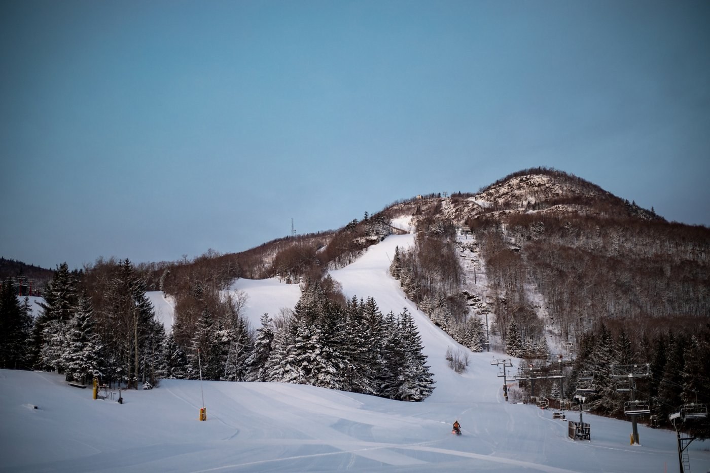 Snowy ski terrain and chairlift at Hunter Mountain