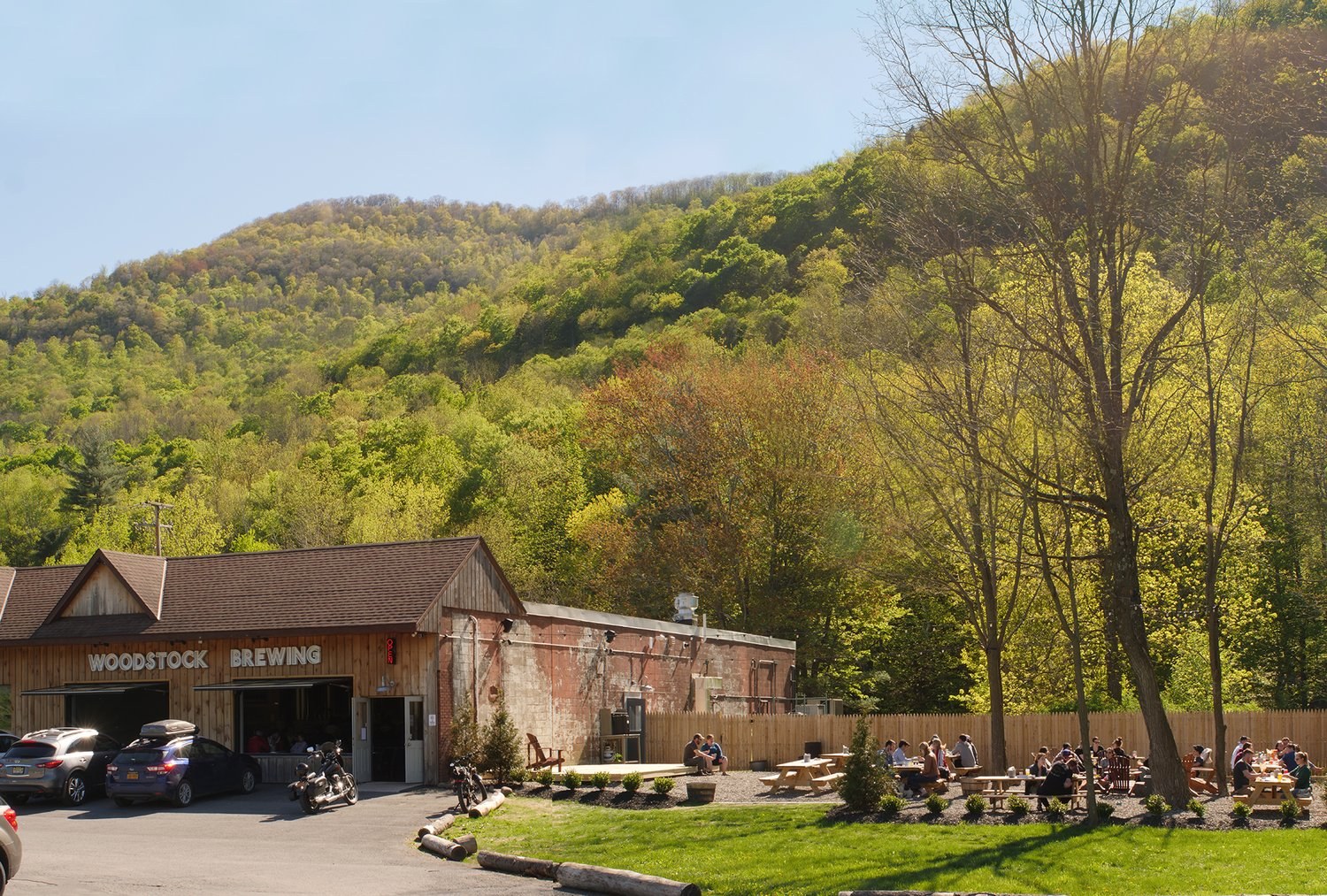 Woodstock Brewing’s taproom and outdoor seating against wooded hills